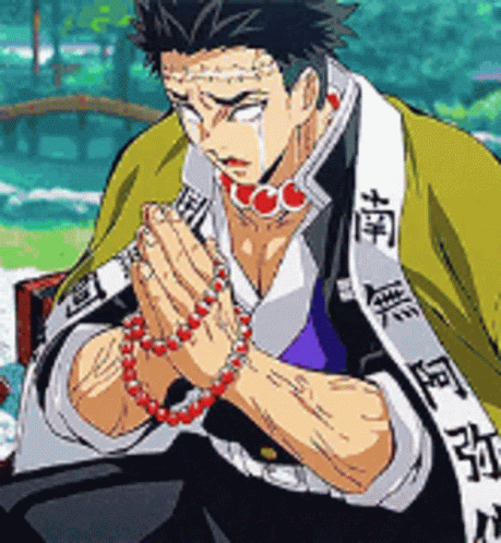 A Man In A Kimono Is Praying With His Hands Folded . GIF
