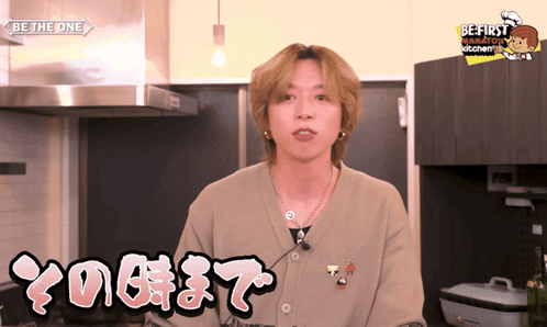 A Man In A Kitchen Wearing A Sweater That Says " Be The One " GIF