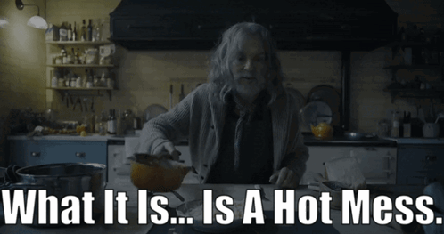 A Man In A Kitchen With The Words " What It Is ... Is A Hot Mess " Above Him GIF