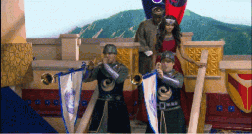 A Man In A Knight Costume Is Playing A Trumpet In Front Of A Woman In A Red Dress GIF
