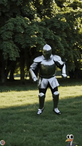 A Man In A Knight 'S Armor Is Standing In A Grassy Field GIF