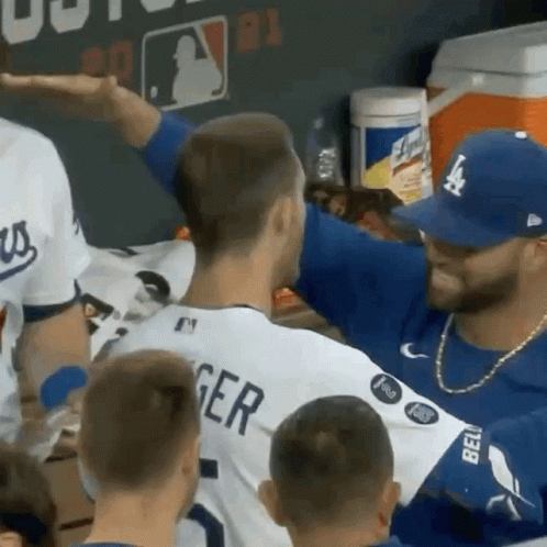 A Man In A La Dodgers Jersey Talks To Another Man GIF