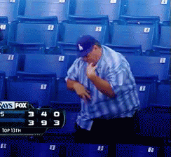 A Man In A La Hat Is Standing In Front Of A Scoreboard That Says Fox GIF