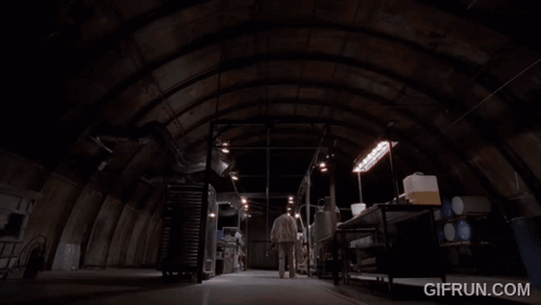 A Man In A Lab Coat Is Touching A Metal Object With The Website Gifrun.com Visible Behind Him GIF