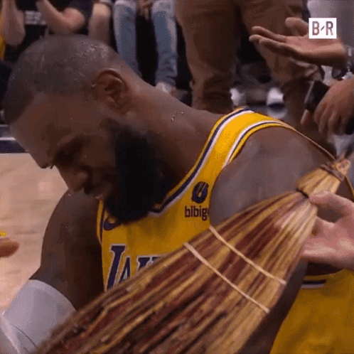 A Man In A Lakers Jersey Is Holding A Bunch Of Money In His Hands GIF