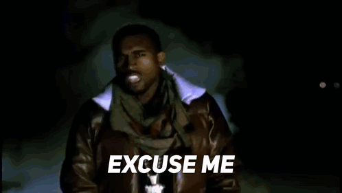 A Man In A Leather Jacket And Scarf Is Standing In Front Of A Blue Background And Says `` Excuse Me '' . GIF