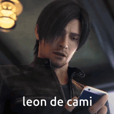 A Man In A Leather Jacket Is Holding A Cell Phone With The Words Leon De Cami Above Him GIF