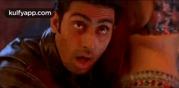 A Man In A Leather Jacket Is Looking At A Woman 'S Waist . GIF