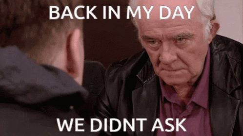 A Man In A Leather Jacket Is Looking At Another Man With The Caption Back In My Day We Didn T Ask GIF