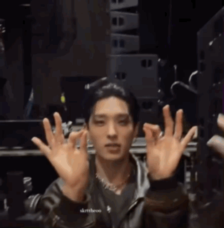 A Man In A Leather Jacket Is Making A Face With His Hands In The Air GIF