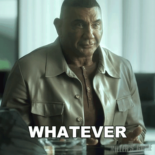 A Man In A Leather Jacket Is Sitting At A Table With The Word Whatever In White Letters GIF