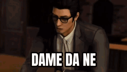 A Man In A Leather Jacket Is Sitting At A Table With The Words `` Dame Da Ne '' Written On The Screen . GIF