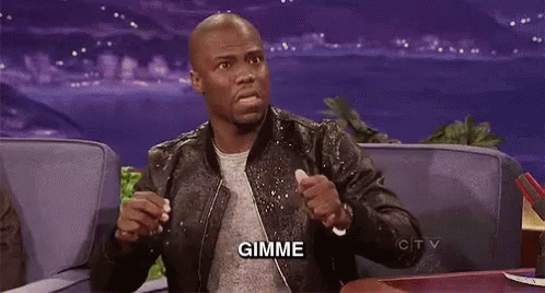 A Man In A Leather Jacket Is Sitting On A Couch With His Hands In The Air And The Word Gimme Written On The Screen . GIF