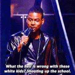 A Man In A Leather Jacket Is Speaking Into A Microphone . GIF