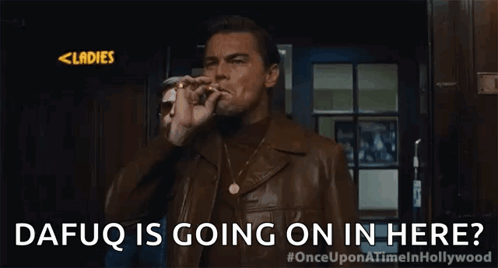 A Man In A Leather Jacket Is Standing In Front Of A Door And Asking If Dafuq Is Going On In Here . GIF
