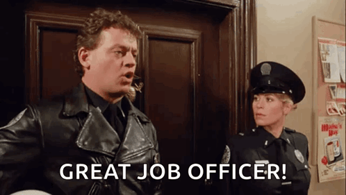 A Man In A Leather Jacket Is Standing Next To A Woman In A Police Uniform And Says `` Great Job Officer '' . GIF