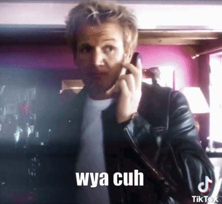 A Man In A Leather Jacket Is Talking On A Cell Phone With A Caption That Says Wya Cuh GIF