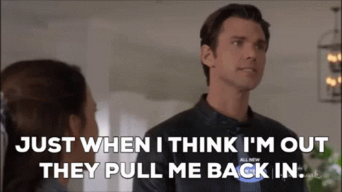 A Man In A Leather Jacket Is Talking To A Woman In A Living Room . GIF