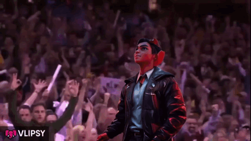 A Man In A Leather Jacket Stands In Front Of A Crowd With The Word Vlipsy On The Bottom GIF