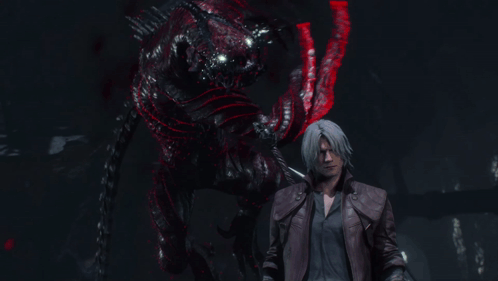 A Man In A Leather Jacket Stands In Front Of A Demon With Red Eyes GIF