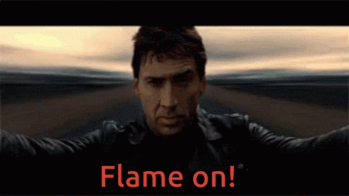 A Man In A Leather Jacket Stands In Front Of A Flame On Sign GIF