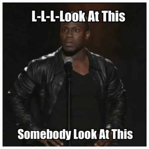 A Man In A Leather Jacket Stands In Front Of A Microphone With The Caption L-L-L-Look At This GIF