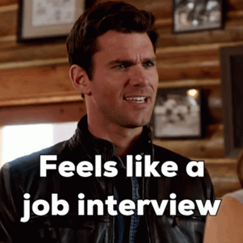 A Man In A Leather Jacket With The Words " Feels Like A Job Interview " Above Him GIF