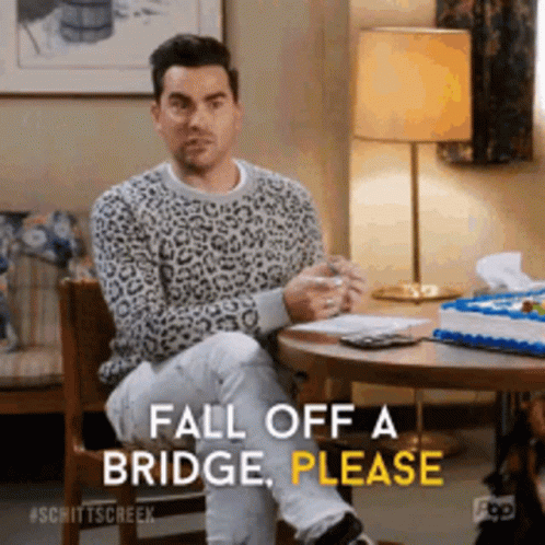 A Man In A Leopard Print Sweater Is Sitting At A Table And Saying Fall Off A Bridge Please GIF