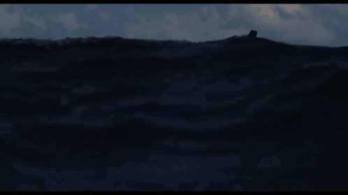 A Man In A Life Preserver Is Floating In The Ocean GIF