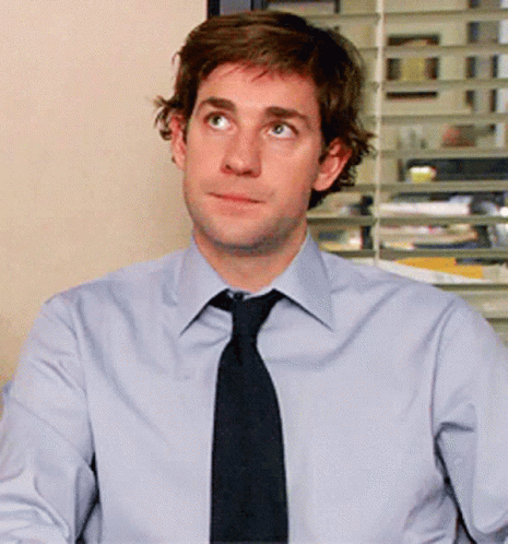 A Man In A Light Blue Shirt And Black Tie GIF
