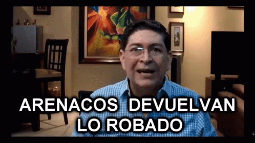 A Man In A Living Room With The Words Arenacos Devuelvan Lo Robado GIF