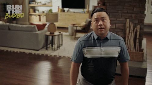 A Man In A Living Room With The Words Run The Burbs On The Bottom Right GIF