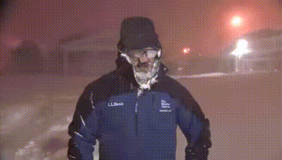 A Man In A Ll Bean Jacket Is Standing In The Snow At Night GIF