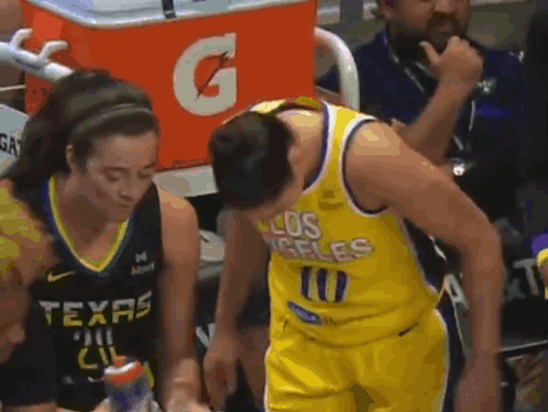 A Man In A Los Angeles Jersey Is Talking To A Woman In A Texas Jersey . GIF