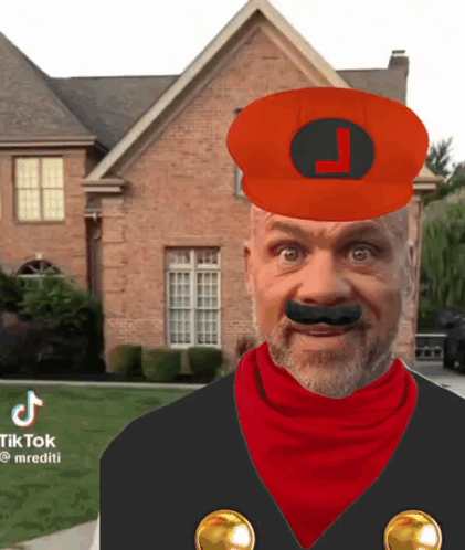 A Man In A Mario Costume Is Standing In Front Of A Brick House With A Red Hat And Mustache . GIF