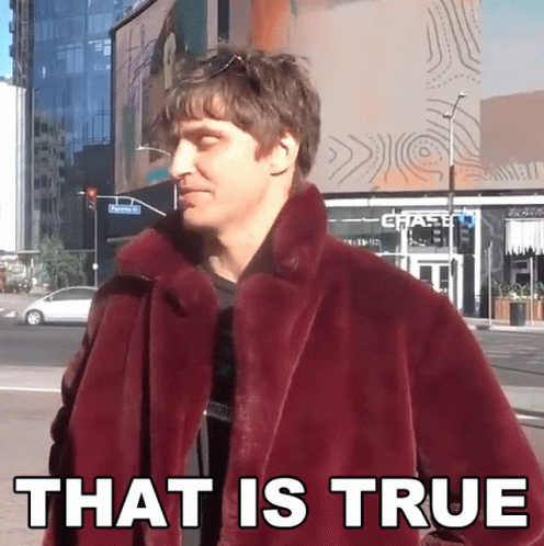 A Man In A Maroon Coat Says That Is True In Front Of A Chase Bank GIF