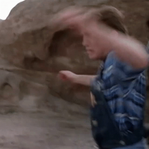 A Man In A Mask Is Being Punched In The Face GIF