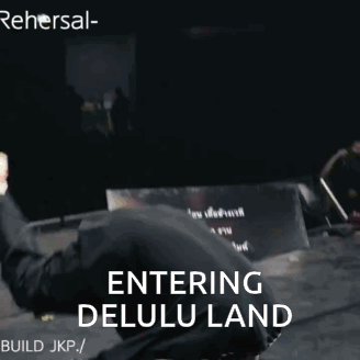 A Man In A Mask Is Doing A Trick With The Words Entering Delulu Land Behind Him GIF