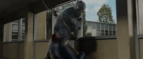A Man In A Mask Is Fighting Another Man In A Room GIF