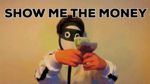 A Man In A Mask Is Holding A Bunch Of Money In Front Of His Face With The Words Show Me The Money Behind Him GIF