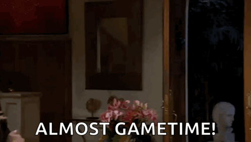 a man in a mask is peeking out of a door with the words almost gametime below him