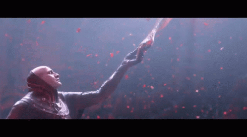 A Man In A Mask Is Reaching Up Towards The Sky GIF