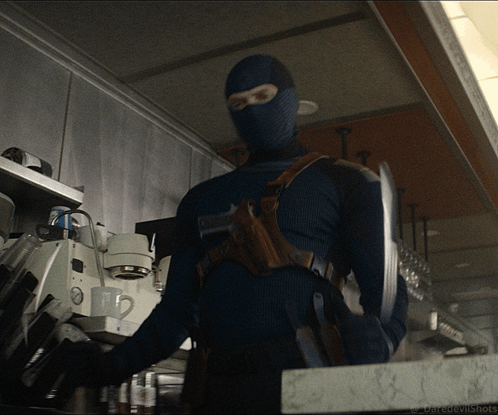 A Man In A Mask Is Standing In A Kitchen With The Words Daredevilshots Written On The Bottom GIF