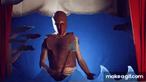 A Man In A Mask Is Standing In Front Of A Red Curtain . GIF