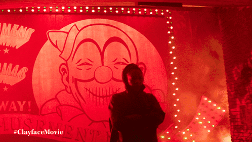 A Man In A Mask Is Standing In Front Of A Sign That Says ' Lust ' On It GIF