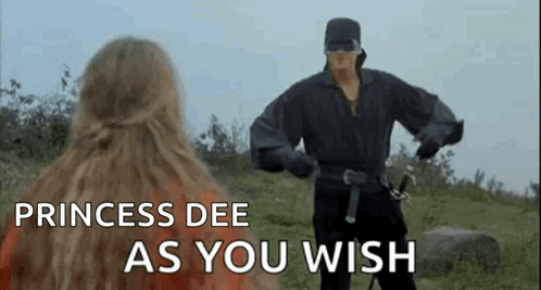 A Man In A Mask Is Standing Next To A Woman In A Field With The Words `` Princess Dee As You Wish '' . GIF