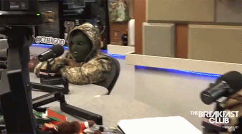 A Man In A Mask Sits In Front Of A Microphone With The Breakfast Club Written On The Bottom GIF