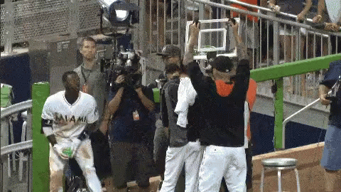A Man In A Miami Jersey Stands In Front Of A Camera GIF