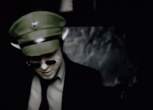 A Man In A Military Hat And Sunglasses Stands In Front Of A Sign That Says Do You Know What That Means GIF