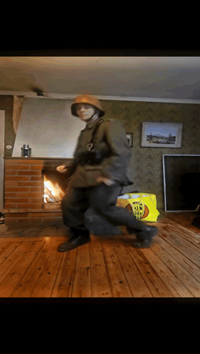 A Man In A Military Uniform Dancing In A Living Room GIF